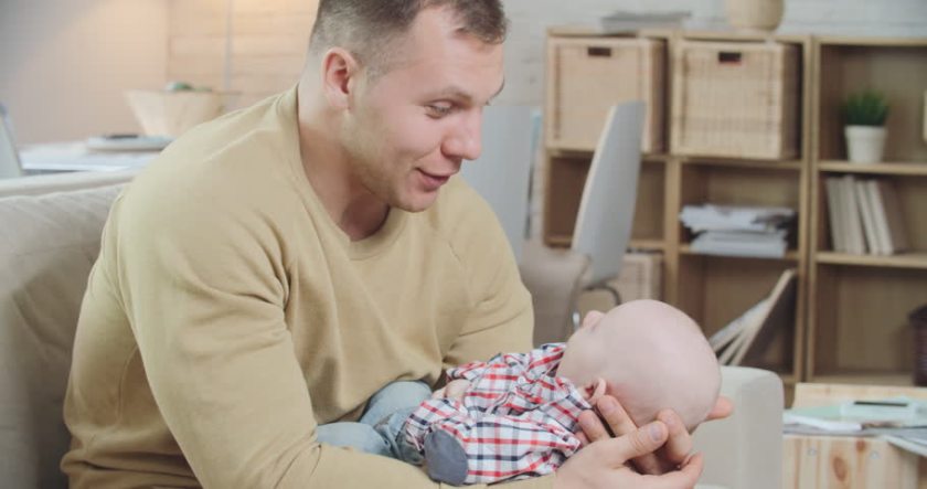 father cradling a child